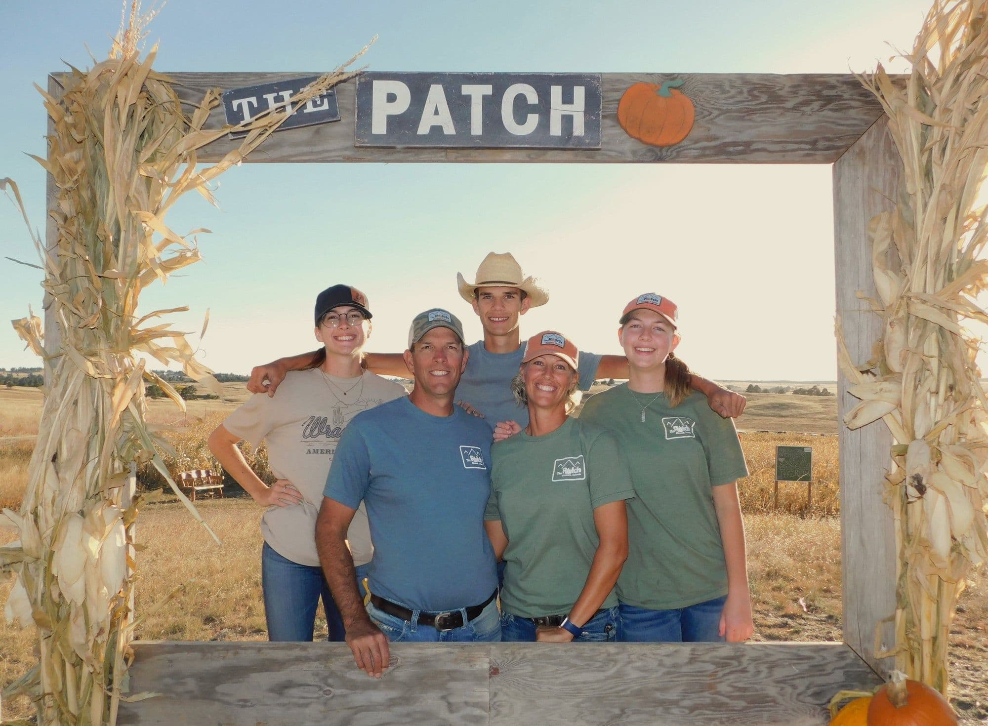 The Smith family standing under the entrance arch at The Patch